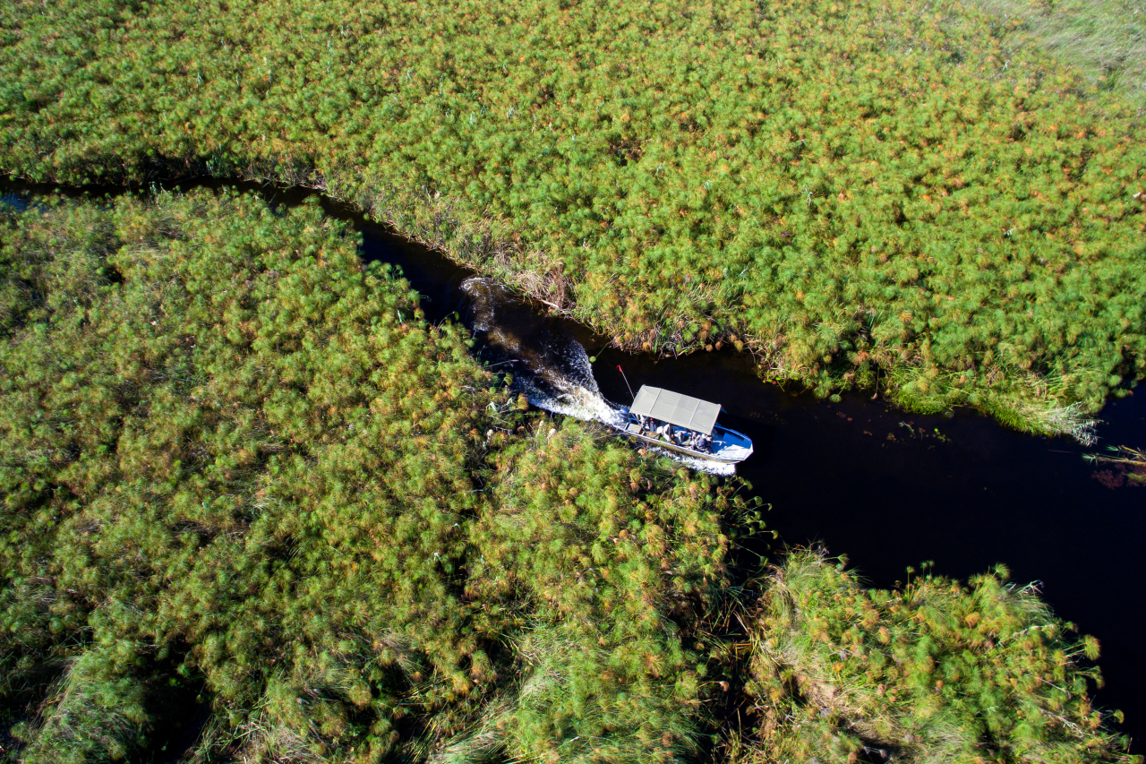 Botswana Nxabega Okavango Tented Camp Aerial view of boat cruise High Resolution Width5000px
