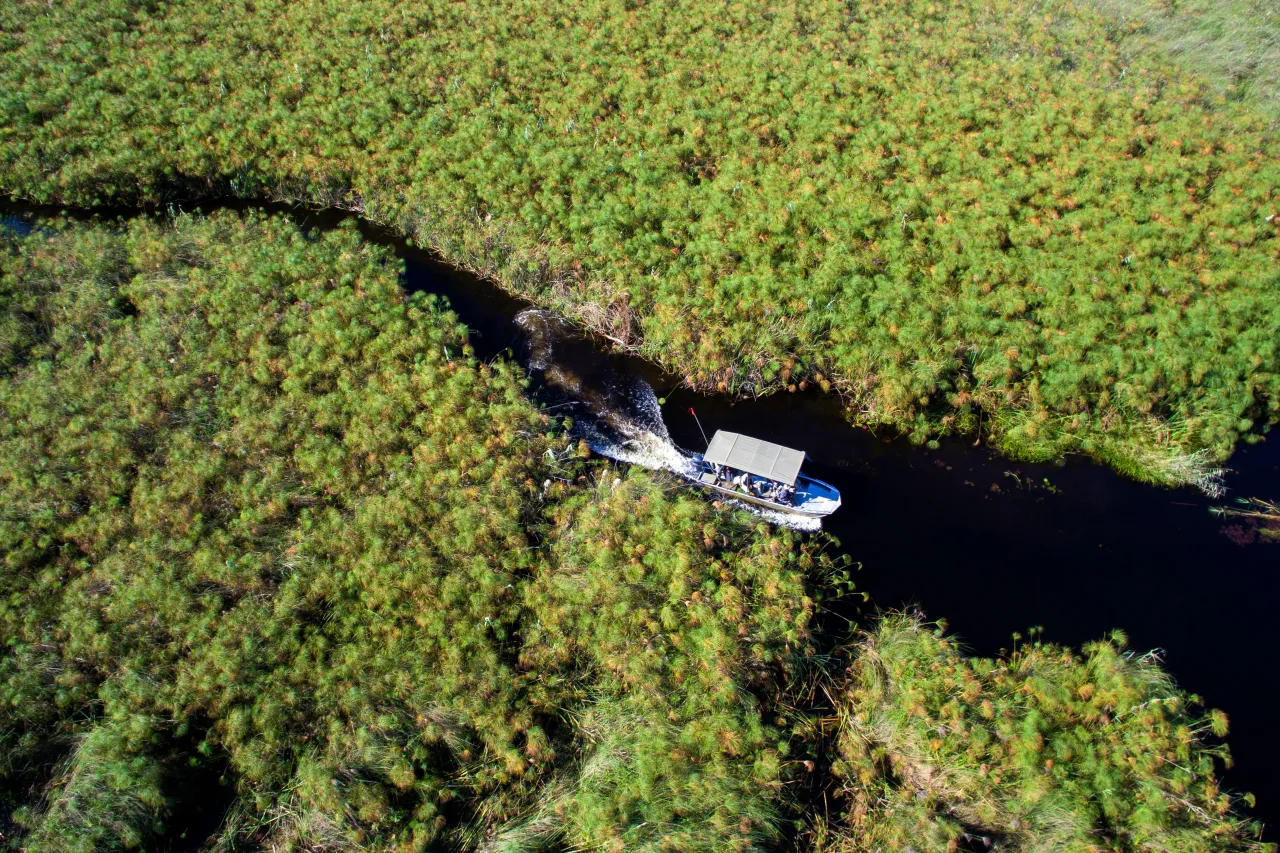 Botswana Nxabega Okavango Tented Camp Aerial view of boat cruise High Resolution Width5000px