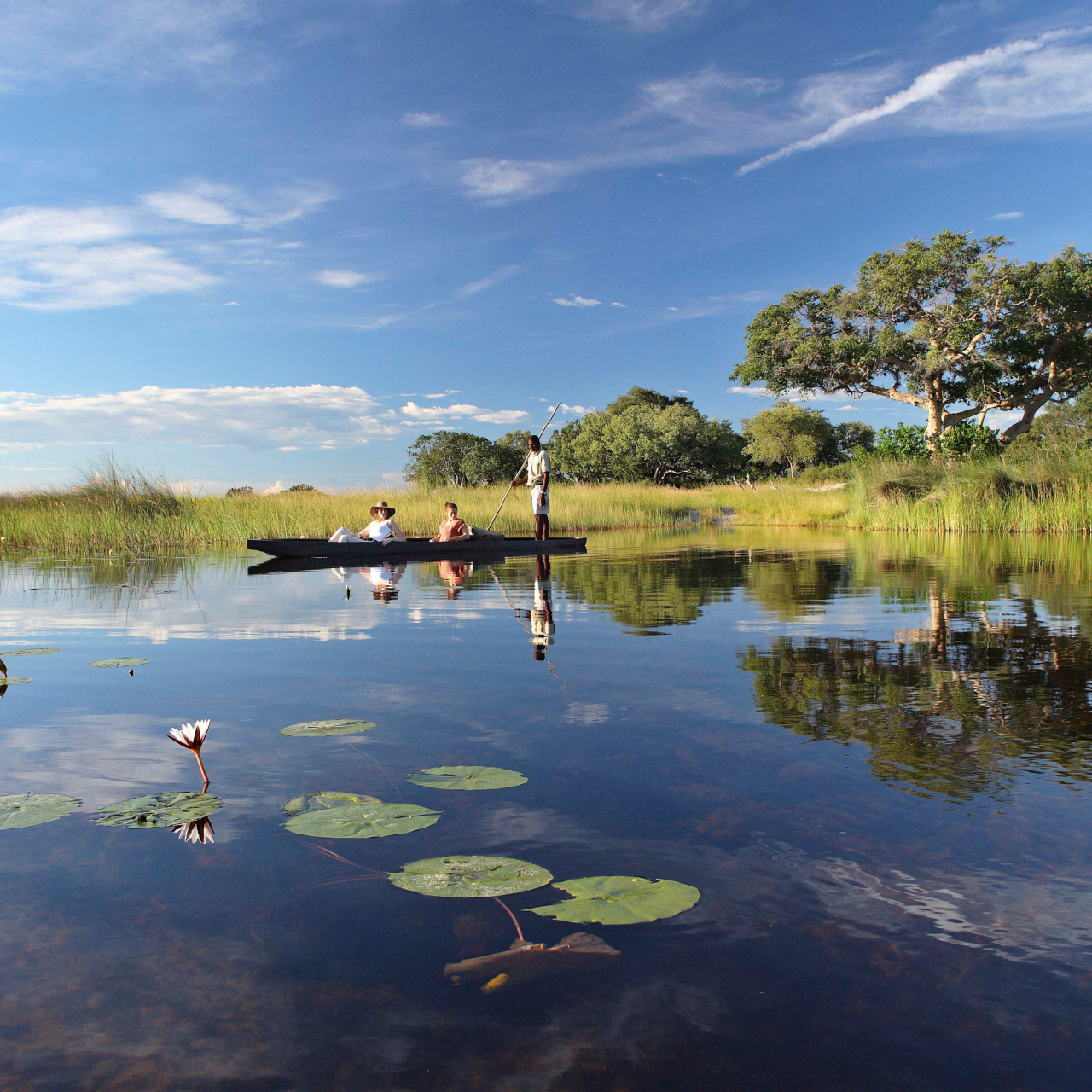Botswana Xaranna Experience Mokoro ride guests lounging on the Mokoro High Resolution Width5000px